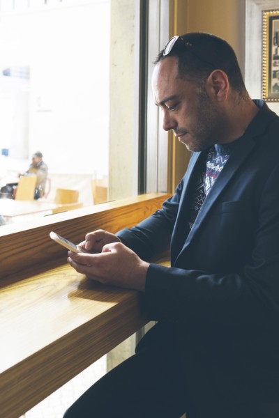 Man using smart phone in cafe
