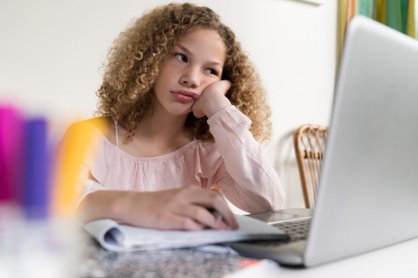Bored girl using laptop