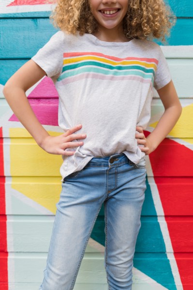 Girl in front of colorful wall