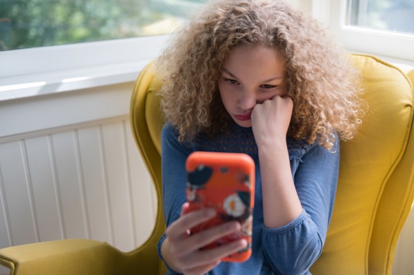 Bored girl using smartphone