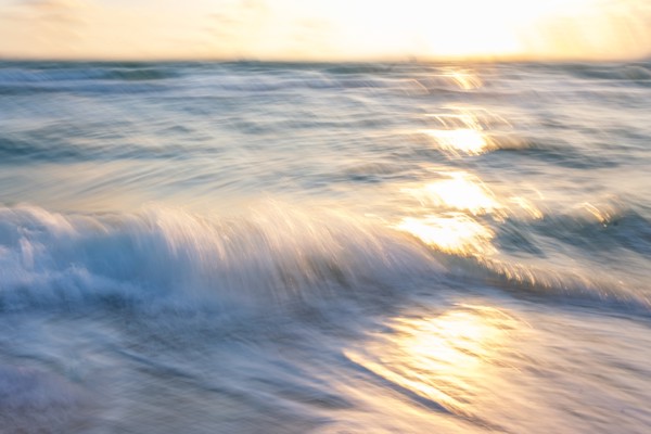 Blurred image of sun reflecting on waves