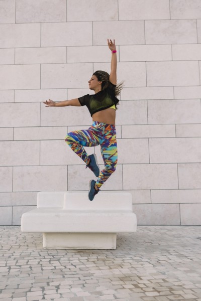 Woman jumping by wall
