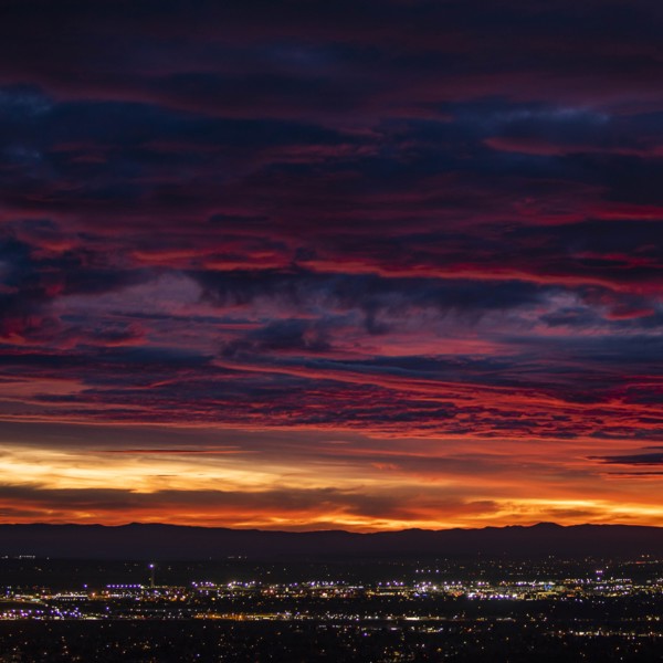 Cityscape under dramatic sky at sunset