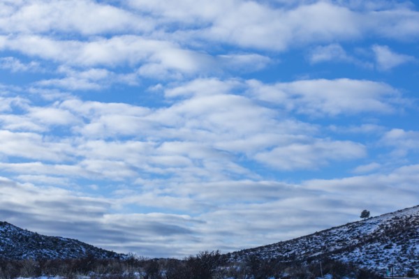 Snowy hills under cloud