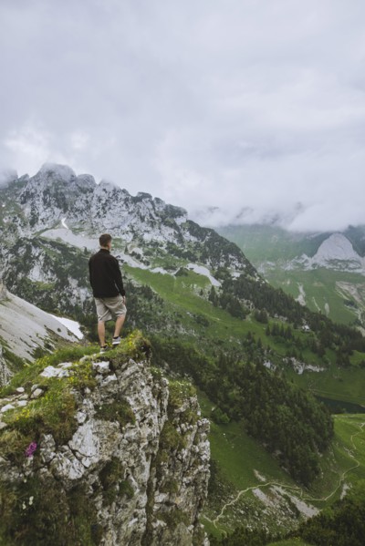 Man on rock by mountains