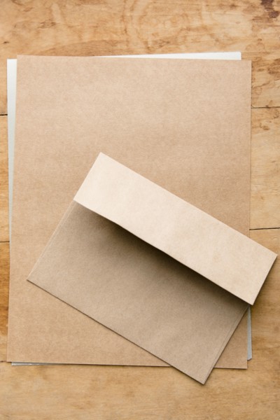 Envelope and paper on wooden table