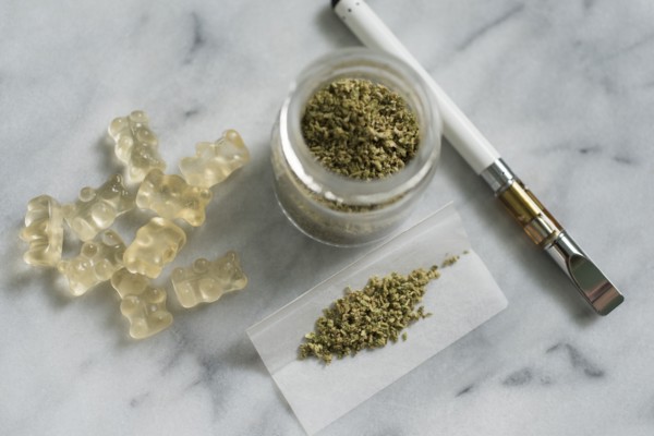 Gummi bear edibles, marijuana in jar and rolling paper, and electronic cigarette