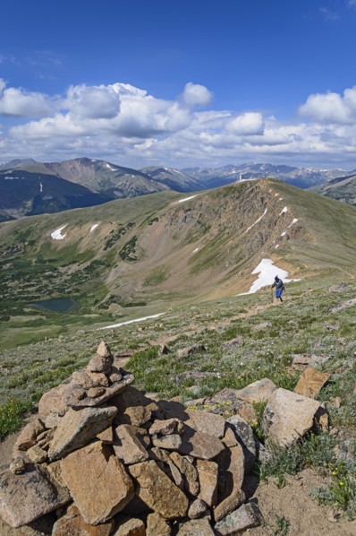 Cairn and woman hiking on Berthoud Pass Trail in Colorado