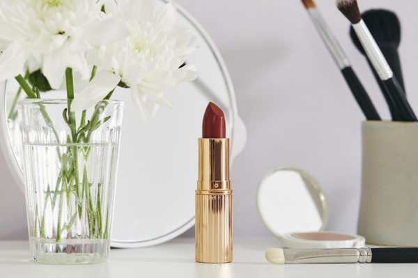 Flowers and make-up on white table