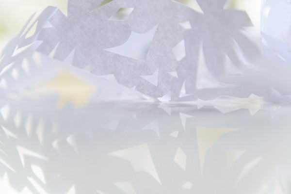 Paper snowflake on glass table