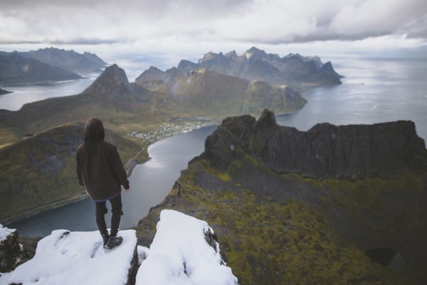 young man hiking on mountain in Norway