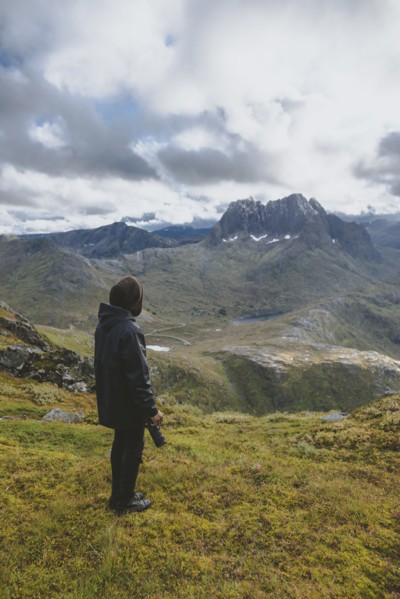 young man hiking on mountain in Norway
