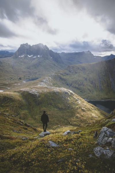 young man hiking on mountain in Norway