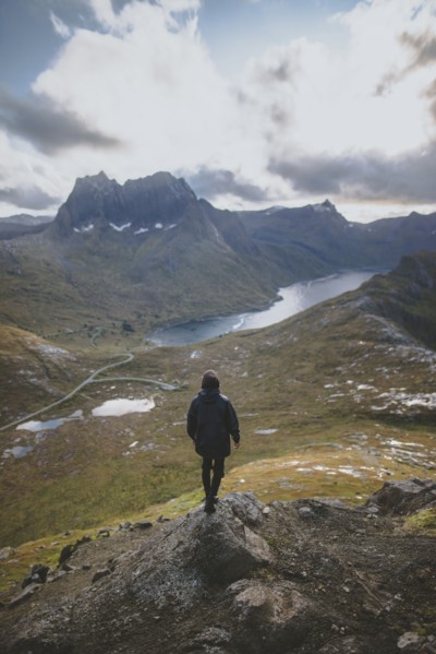 young man hiking on mountain in Norway