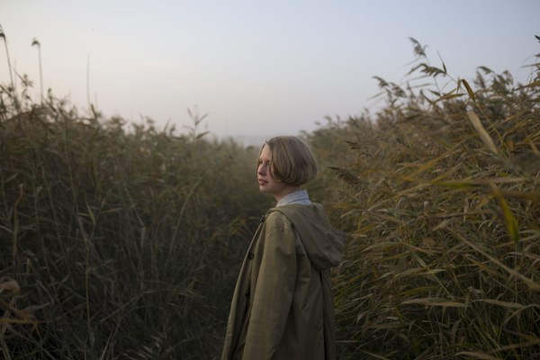young woman in field of long grass