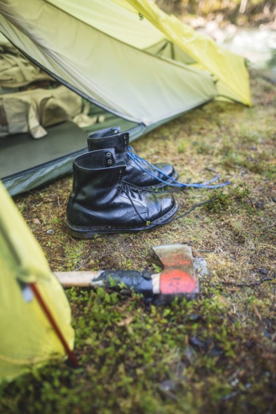 Boots and hatchet by tent