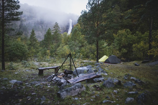 Cooking pot on tripod above campfire