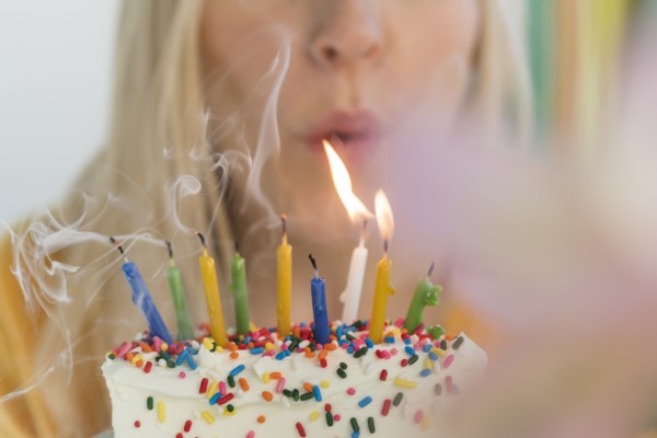 Woman blowing out birthday candles