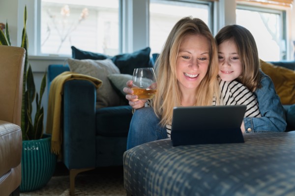 Mother and daughter (6-7) looking at laptop at home