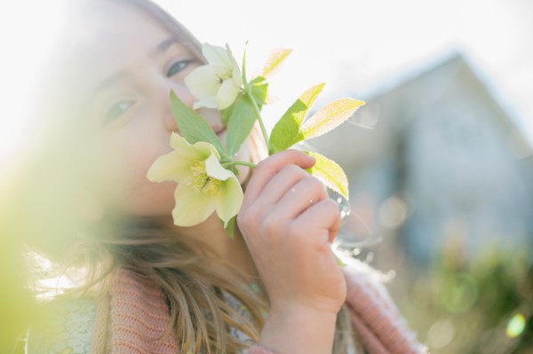 Portrait of girl smelling yellow flowers