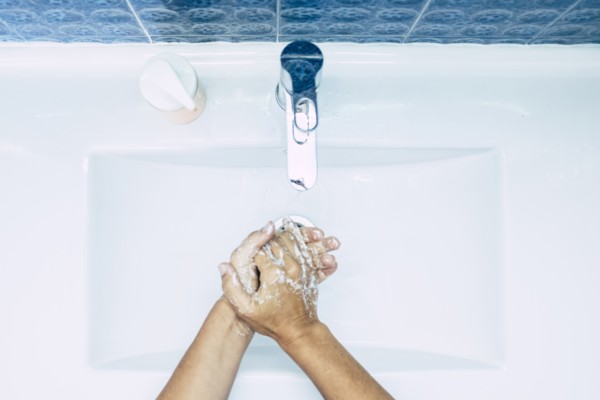 Close-up of teenage boy (16-17) washing hands
