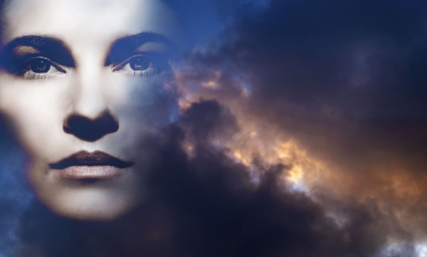 Double exposure of woman and overcast sky
