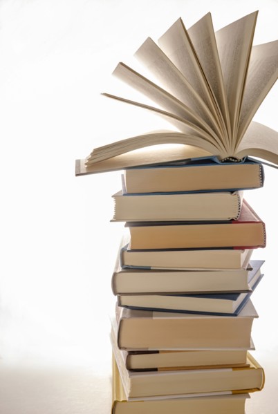Open book on top of stacked books