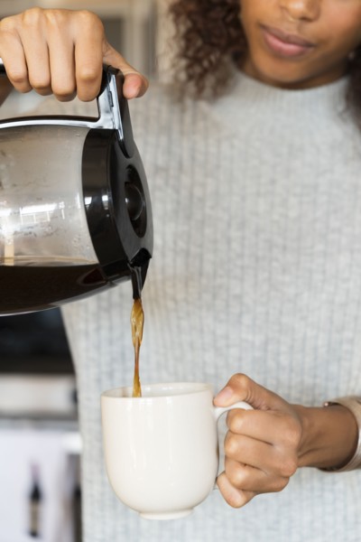Woman pouring cup of coffee