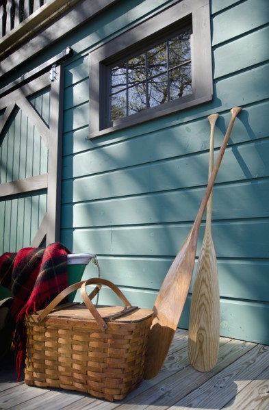 Oars and picnic supplies by blue wall
