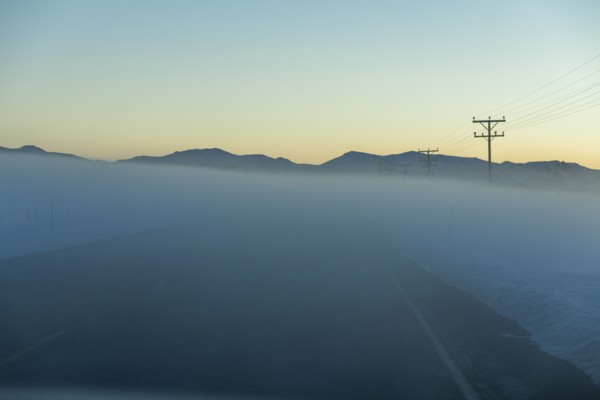 Road in fog at sunrise