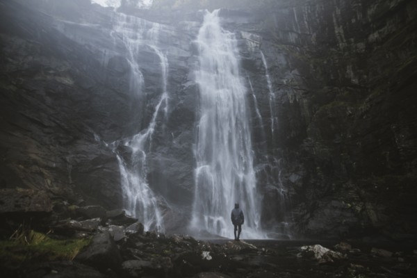 Man standing by Skjervefossen waterfall in Norway