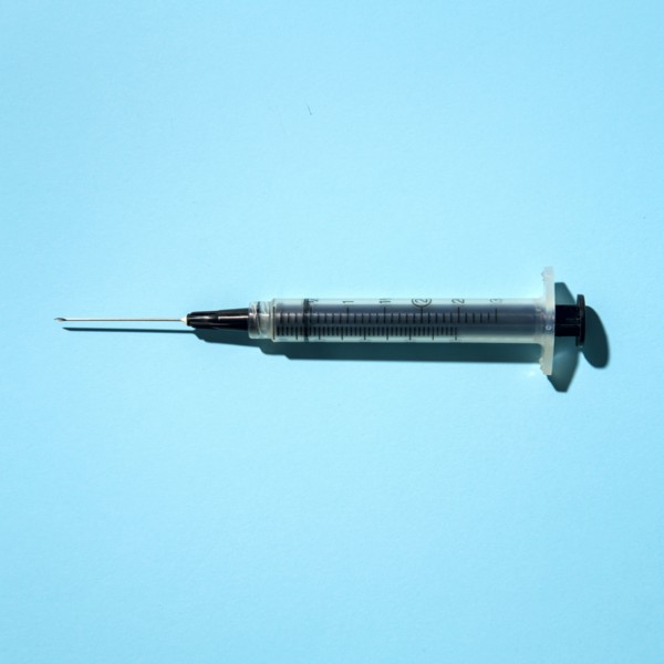 Syringe on blue background