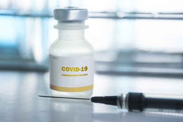 Vial of covid-19 vaccine and hypodermic needle
