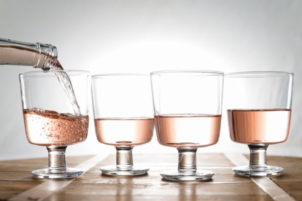 Rose wine being poured into glasses