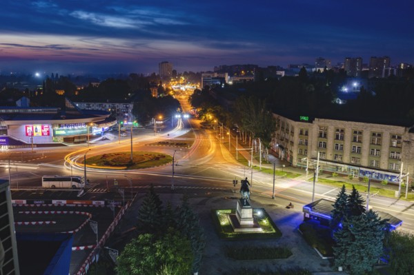 Moldova, Chisinau, Cityscape illuminated at dusk