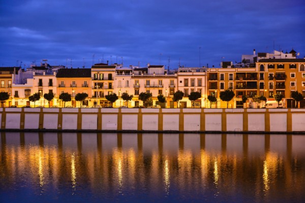 Spain, Seville, Triana, Triana neighborhood reflecting in Guadalquivir River