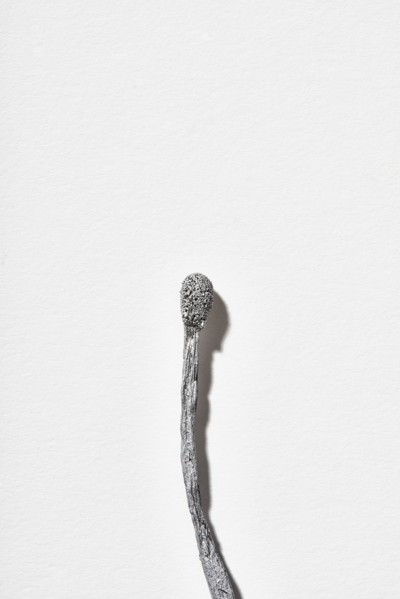 Burnt matchstick on white background