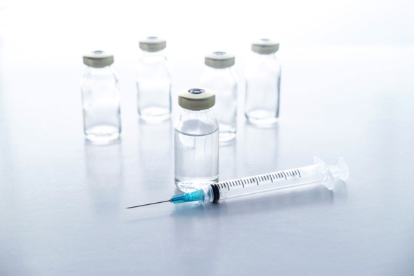 Studio shot of vials and syringe