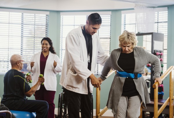Senior people exercising with therapists during physical therapy