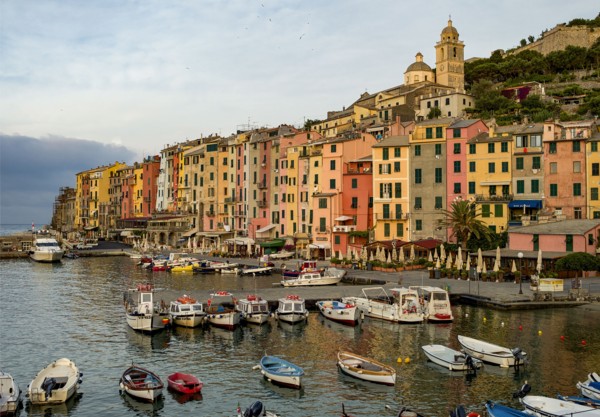 Italy, Cinque Terra, Boats in harbor with town in background