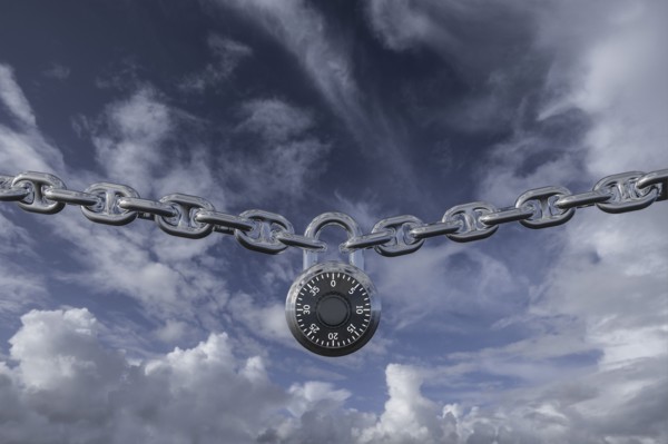 Padlock on chain against clouds