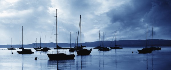 USA, Michigan, Sailboats in harbor at stormy day