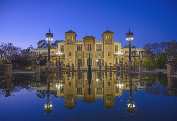 Spain, Seville, Museum of Arts and Popular Customs of Seville reflecting in pond