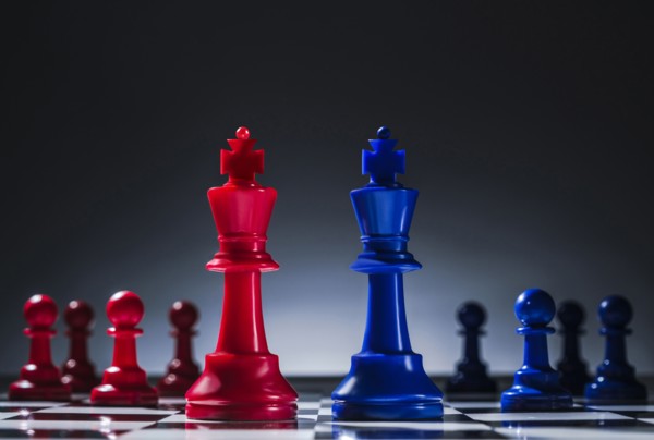 Studio shot of red and blue chess pawns symbolizing US Democratic and Republican parties