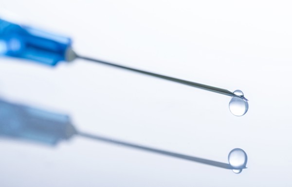 Liquid drop on top of syringe needle