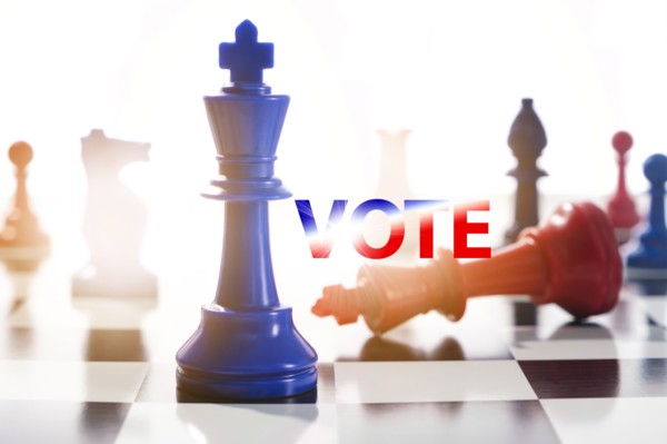 Studio shot of red and blue chess pawns symbolizing US Democratic and Republican parties