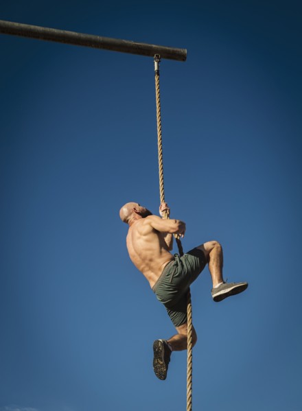 Man climbing on rope