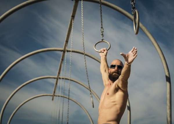Man exercising on gymnastics rings