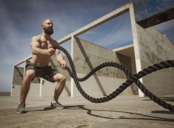 Man exercising with ropes