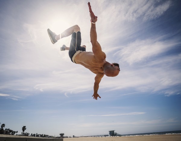 Muscular man exercising on beach